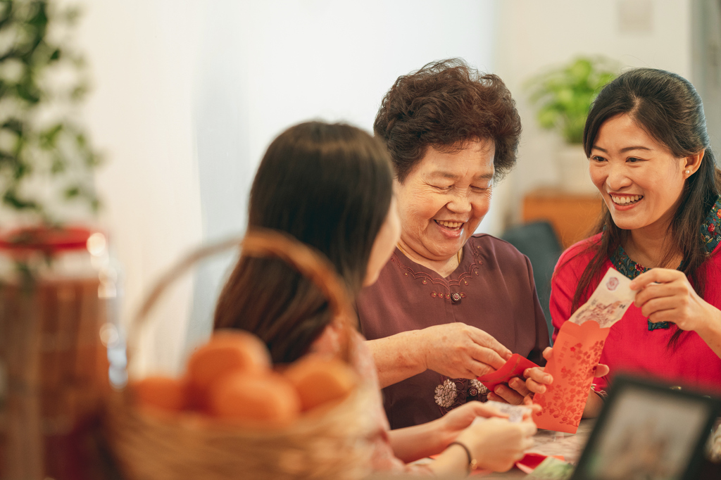 Family members preparing red packets